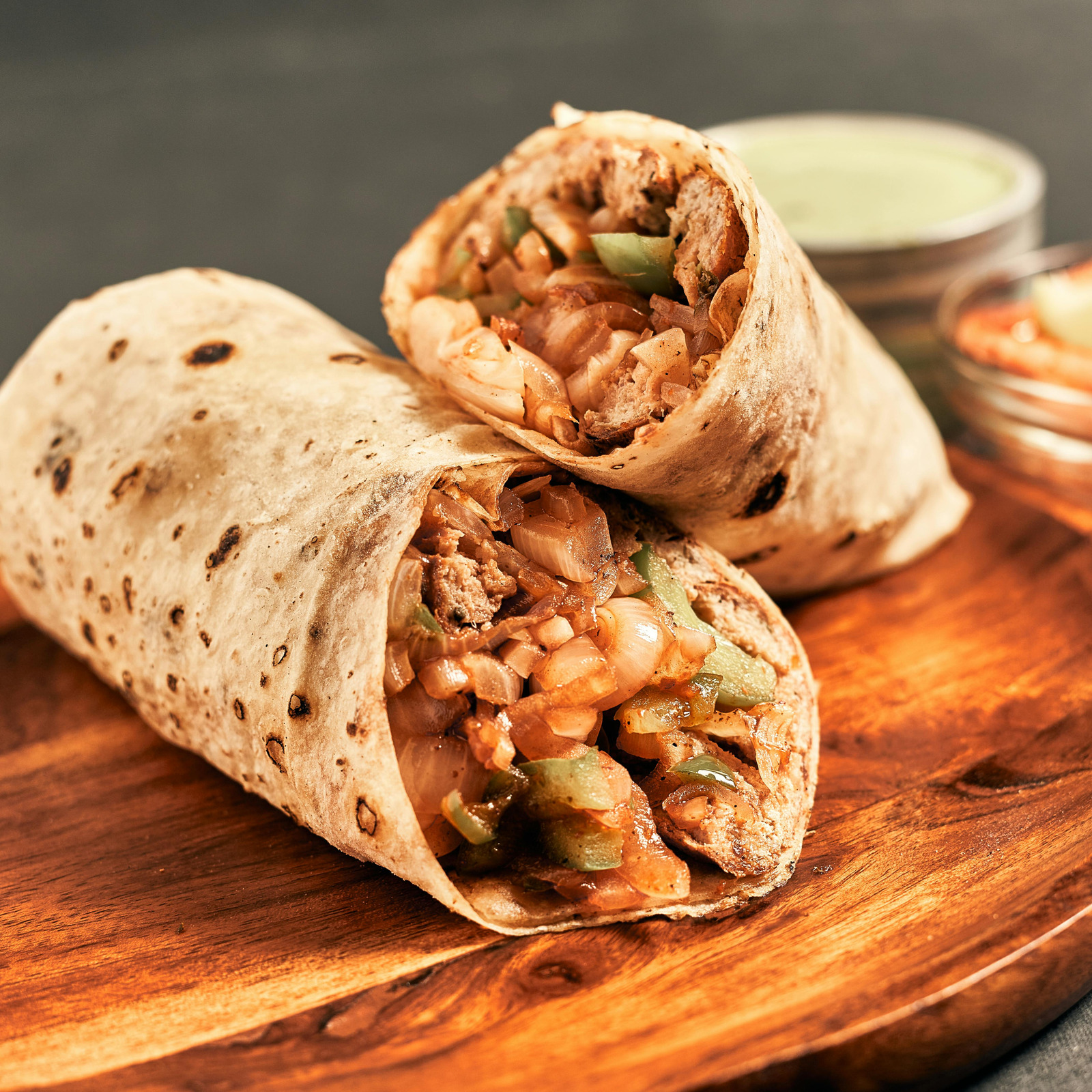 Flame-grilled kebab wraps on a wooden board